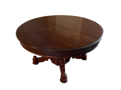 Short, round dark wood table with three legs.